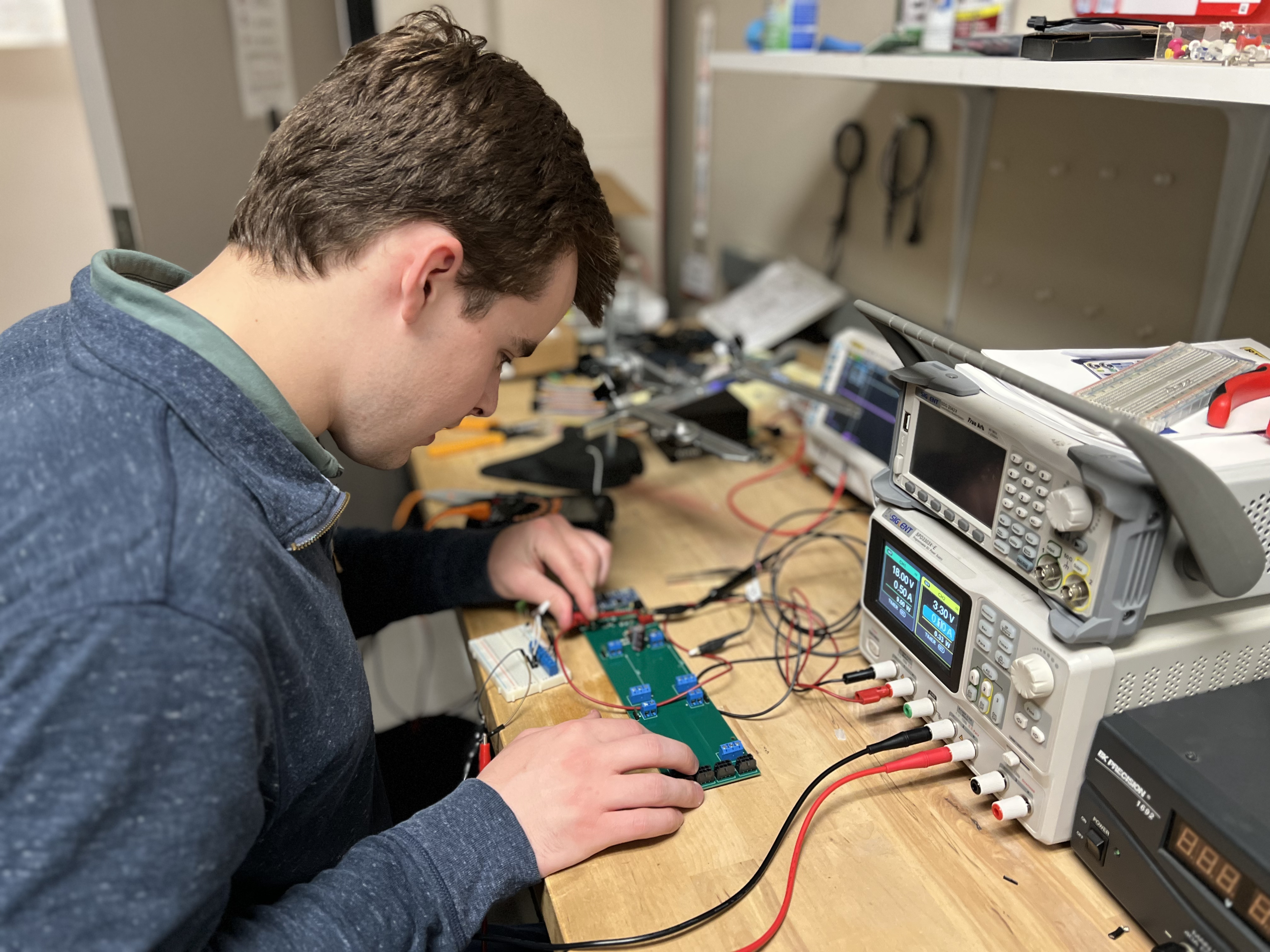 Photo of Sam Saunders working on a PCB